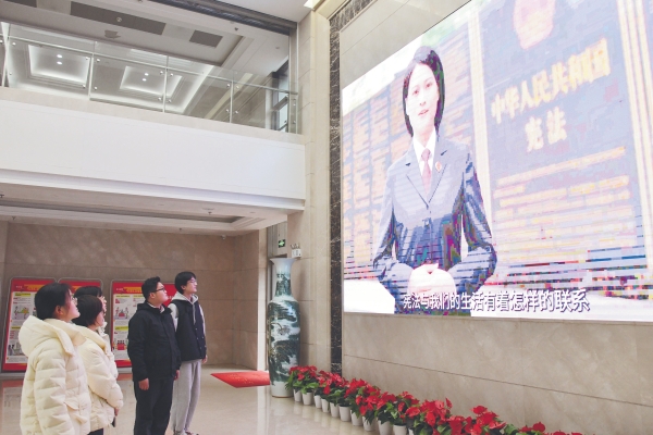 宪法宣传周，中铁四局安装公司本部大厅全天播放最高检制作的国家宪法日宣传视频《美好生活“宪”给你》，经过员工纷纷驻足观看（董双秋 摄）_副本